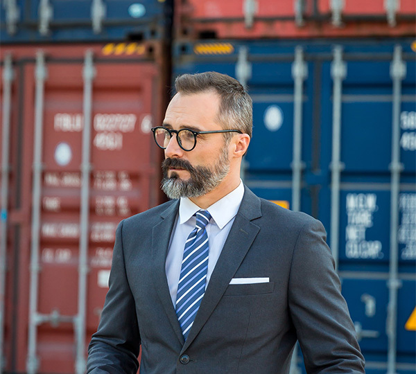 Executive in front of containers